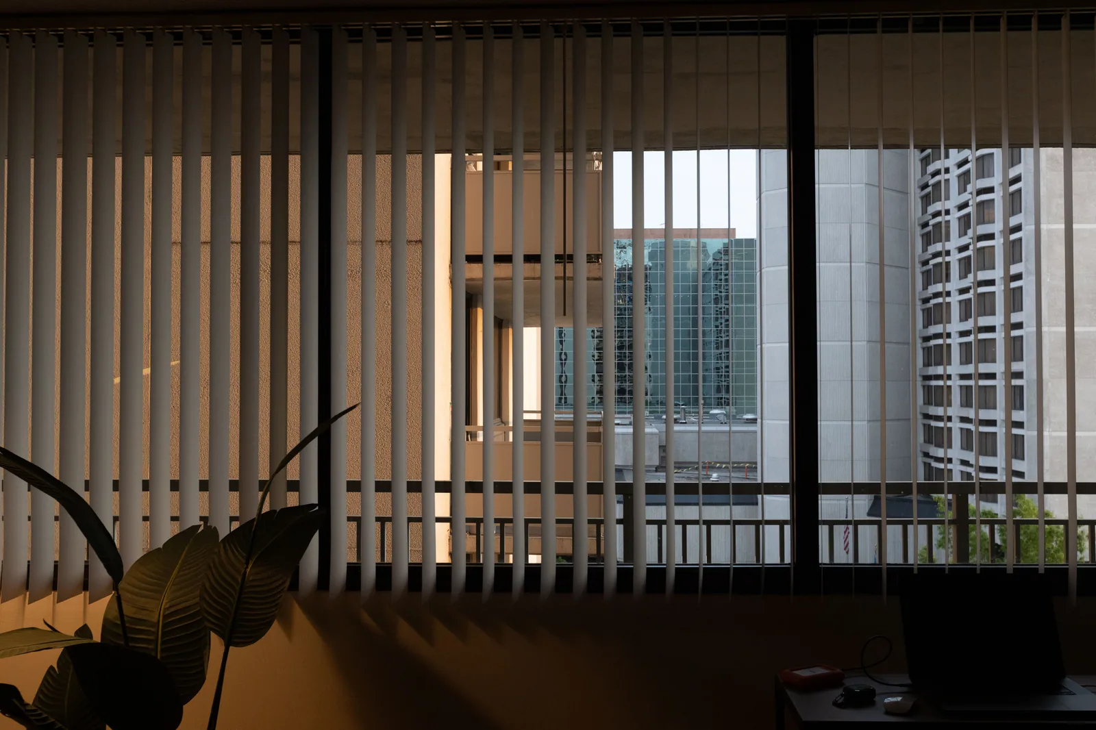 Vertical blinds shaping warm natural light across a modern workspace