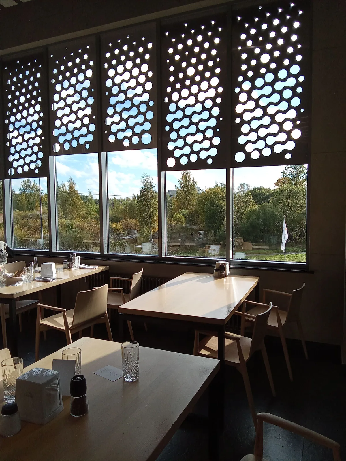 Statement window screens bringing filtered light into a dining space